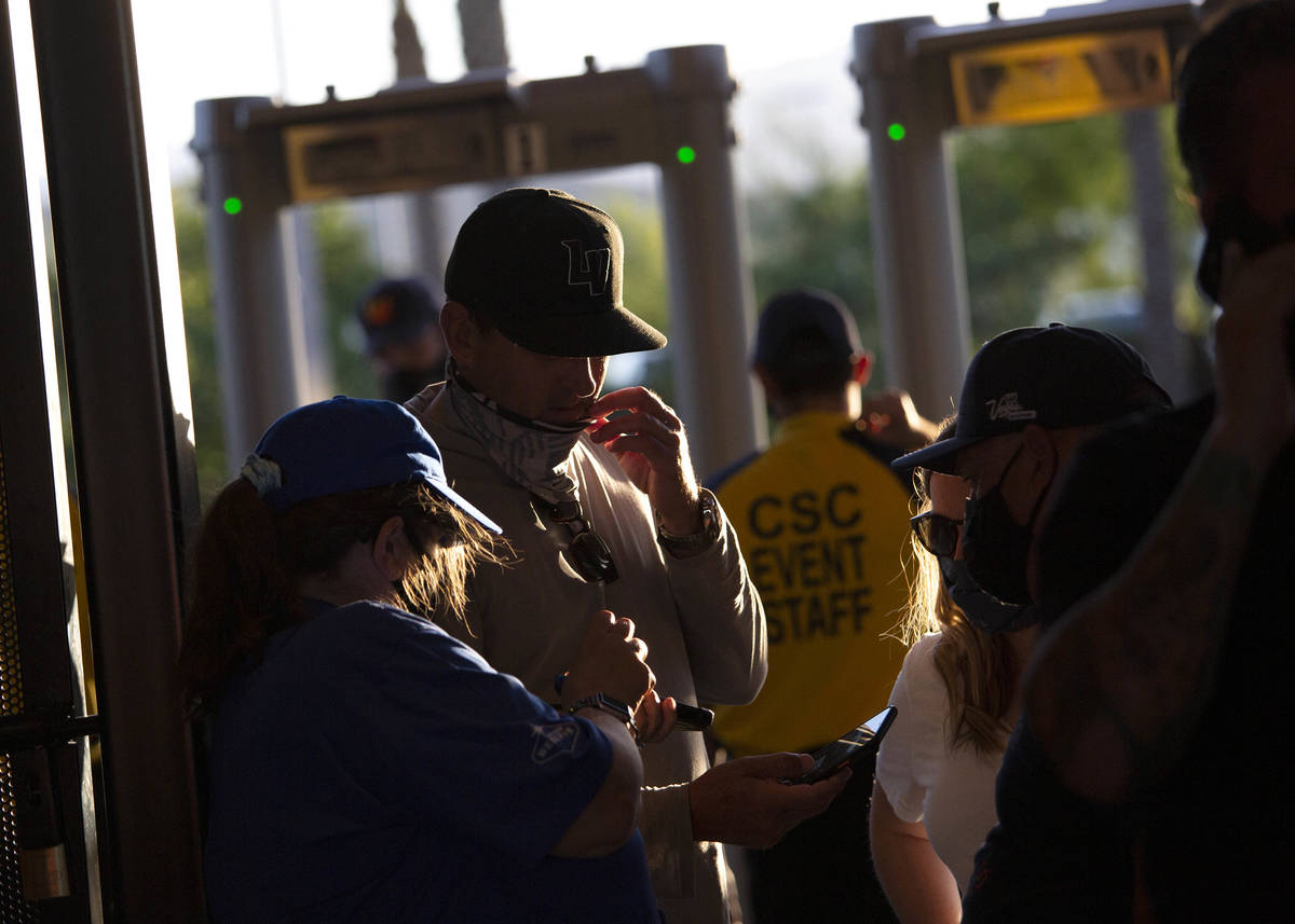Fans show their tickets to get into the Las Vegas Ballpark before a Las Vegas Aviators game aga ...