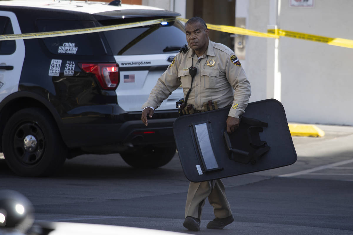 Police investigate the scene of a homicide at the Motel 6 near Koval Lane and Tropicana Avenue ...