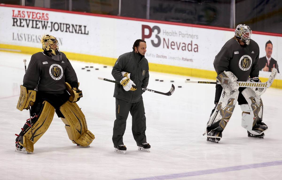 Golden Knights goaltenders Marc-Andre Fleury (29), left, Robin Lehner (90) with coach Mike Rosa ...