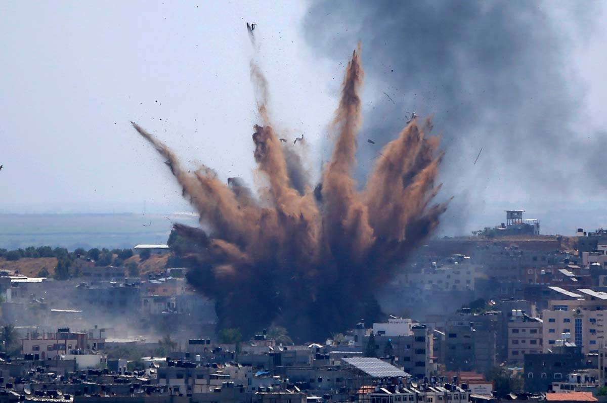 Smoke rises following Israeli airstrikes on a building in Gaza City, Thursday, May 13, 2021. We ...
