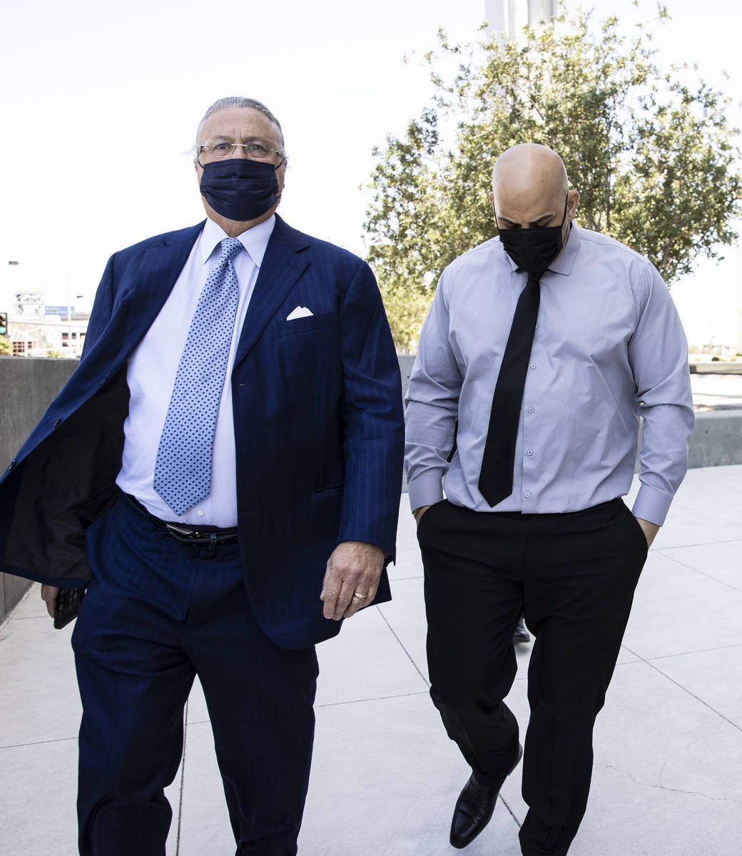 Hip-hop producer known as Mally Mall, right, leaves the Lloyd D. George Federal Courthouse with ...