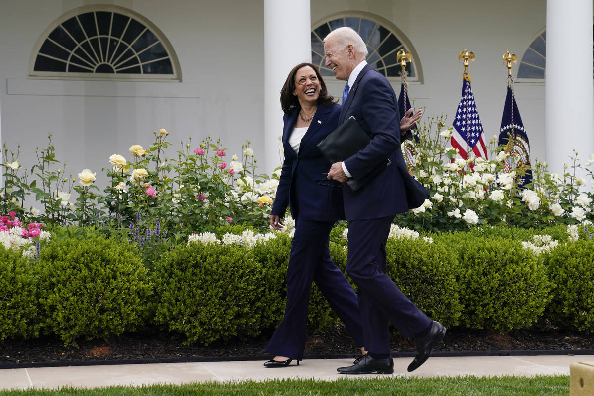 President Joe Biden walks with Vice President Kamala Harris after speaking on updated guidance ...