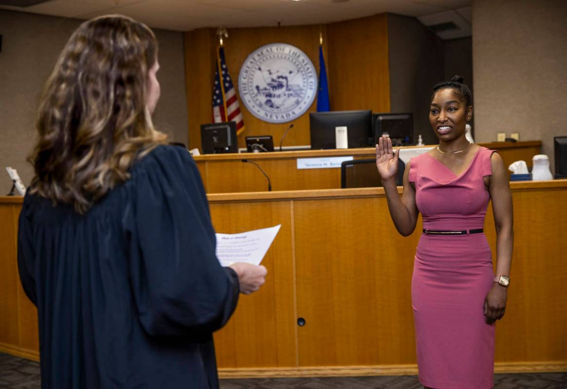 Dominique Bosa-Edwards, right, a former District Court marshal, is sworn in by Judge Veronica M ...
