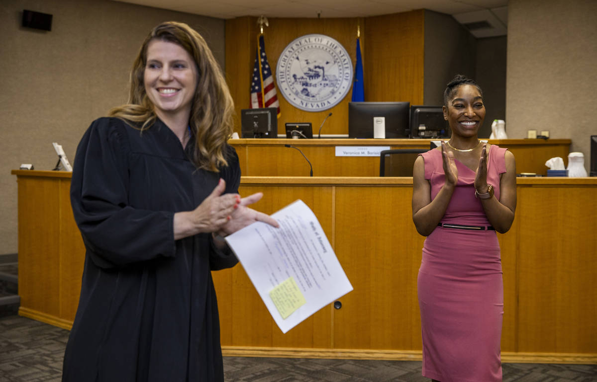 Dominique Bosa-Edwards, right, a former District Court marshal, is applauded after being sworn ...