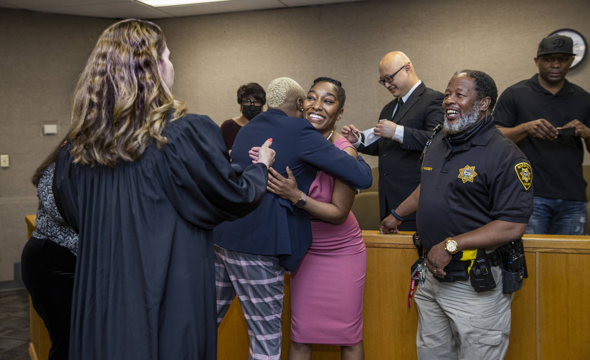 Dominique Bosa-Edwards, center, a former District Court marshal, who passed the Nevada State Ba ...
