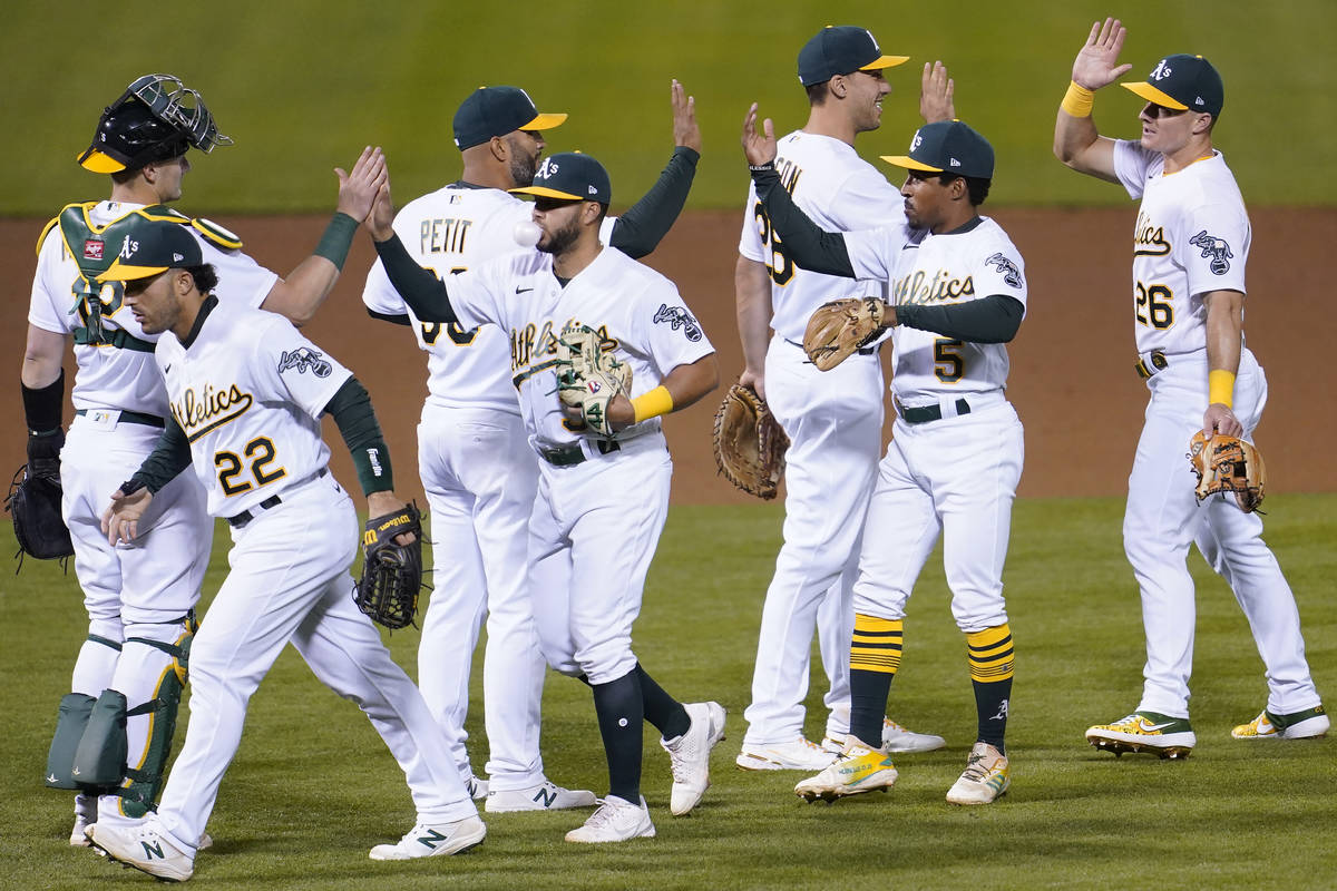 Oakland Athletics' Sean Murphy, from left, celebrates with Ramon Laureano (22), Yusmeiro Petit, ...