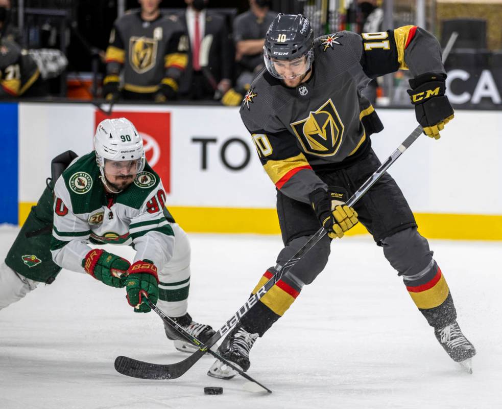 Golden Knights center Nicolas Roy (10) looks to shoot as Minnesota Wild center Marcus Johansson ...