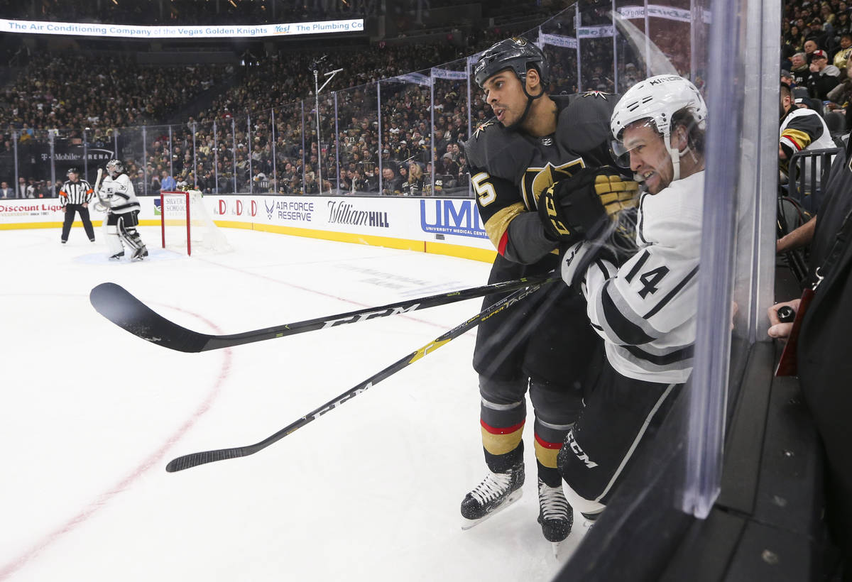 Los Angeles Kings left wing Brendan Leipsic (14) takes a hit from Golden Knights right wing Rya ...