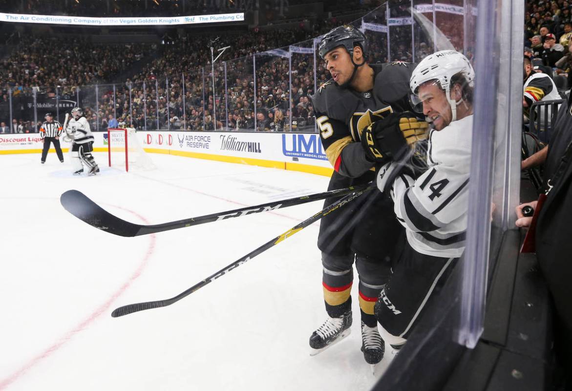 Los Angeles Kings left wing Brendan Leipsic (14) takes a hit from Golden Knights right wing Rya ...