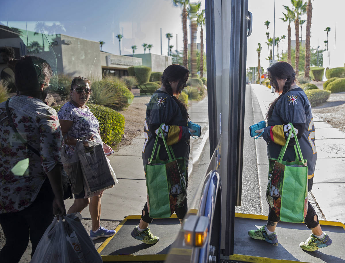Elena Leger, right, boards an RTC bus on East Tropicana Avenue to watch the Vegas Golden Knight ...