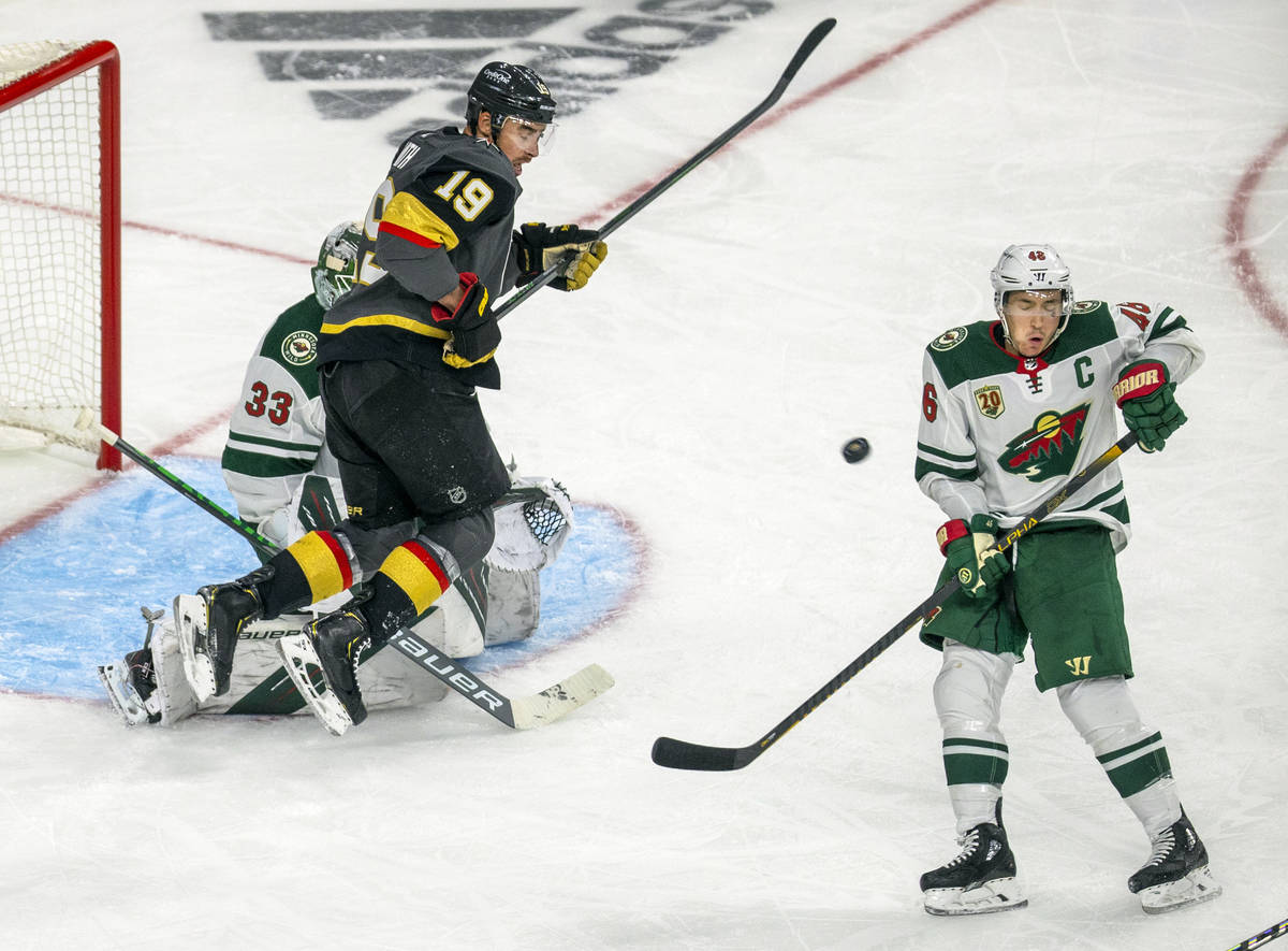 The puck navigates between Minnesota Wild defenseman Jared Spurgeon (46) and Golden Knights rig ...