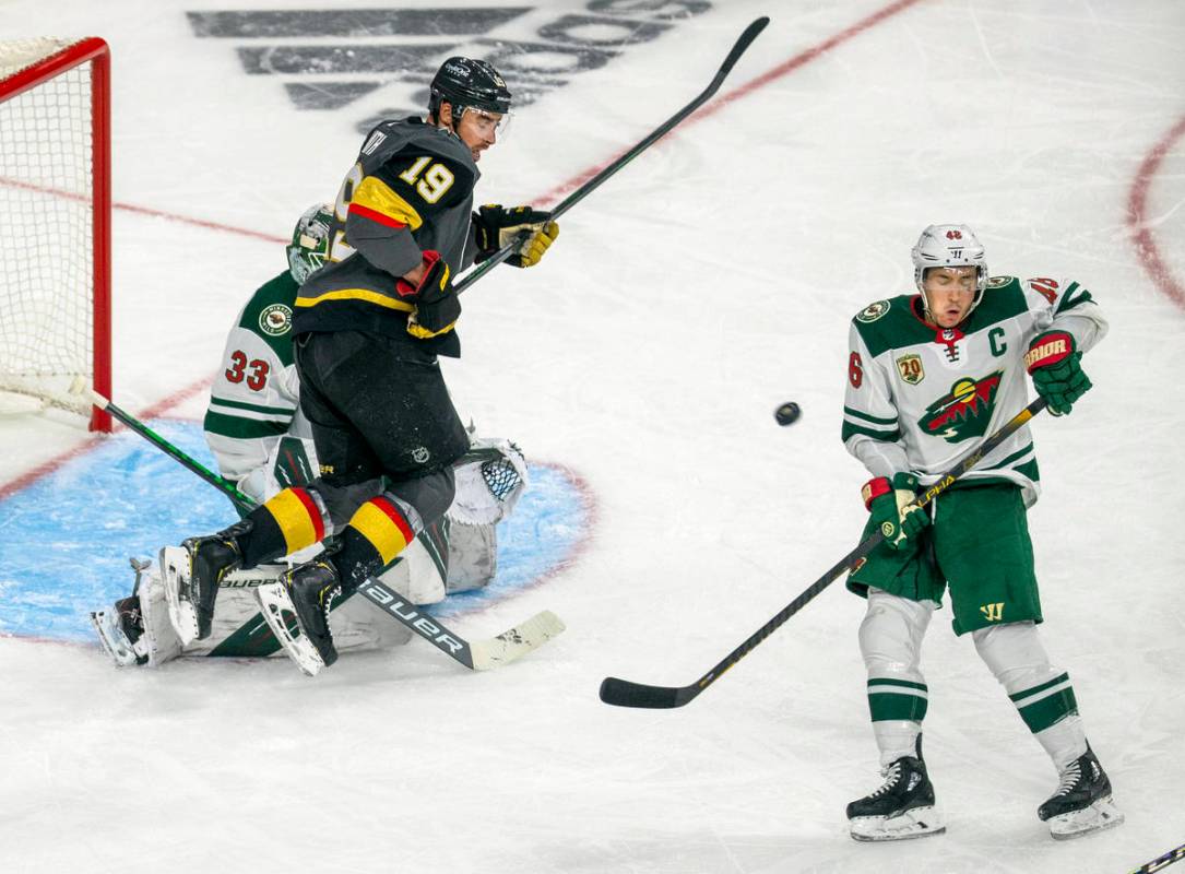 The puck navigates between Minnesota Wild defenseman Jared Spurgeon (46) and Golden Knights rig ...