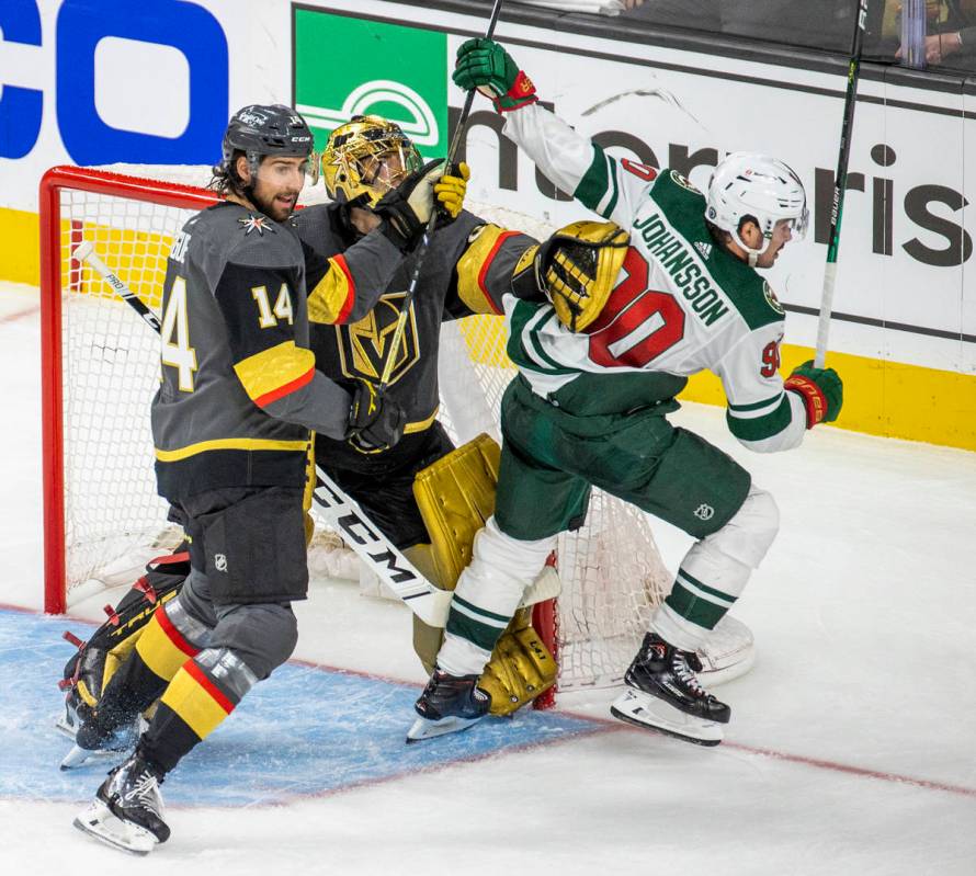 Golden Knights defenseman Nicolas Hague (14) and teammate goaltender Marc-Andre Fleury (29) kee ...