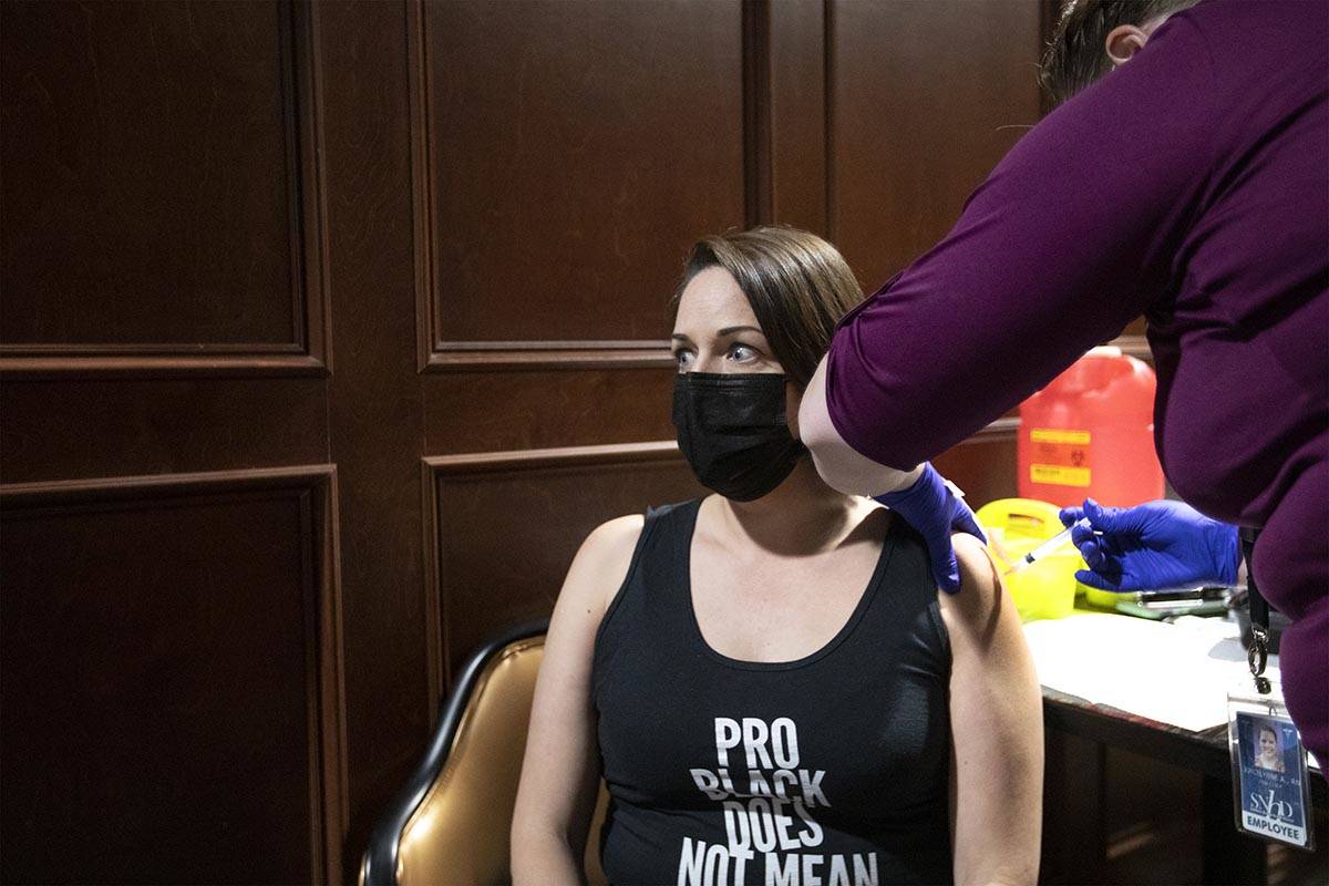 Jennifer Gentry's eyes widen as she receives the Johnson & Johnson COVID-19 vaccine during ...