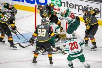 Golden Knights and Minnesota Wild players battle near the net during the third period of an NHL ...