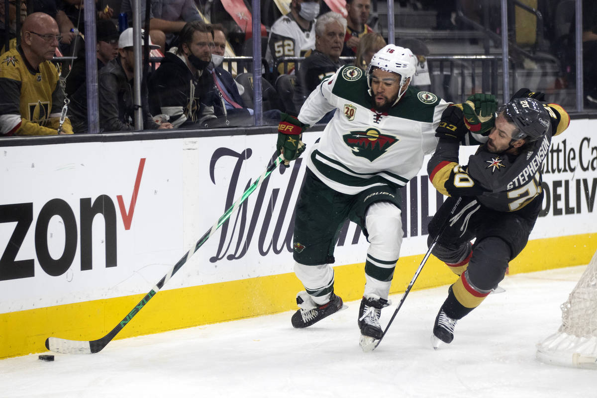 Wild left wing Jordan Greenway (18) shoves Golden Knights center Chandler Stephenson (20) durin ...