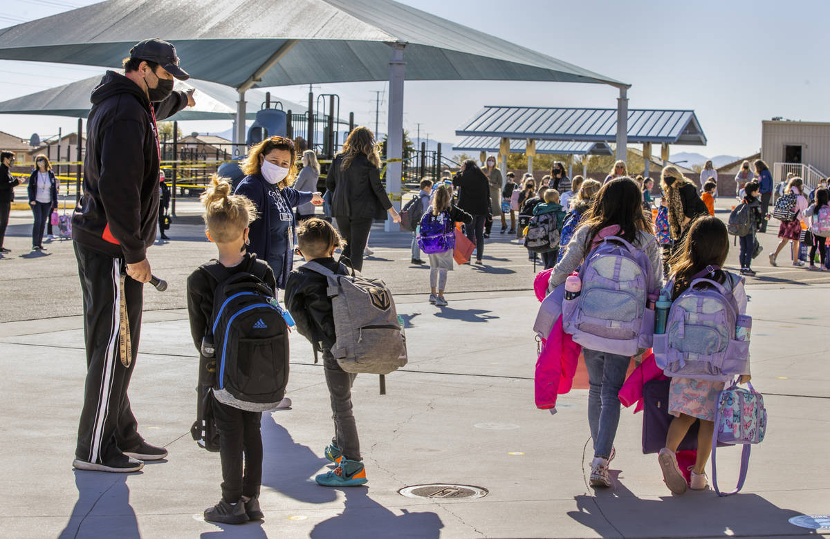 In this March 1, 2021, file photo, physical education teacher Mike Shenkberger, left, and other ...