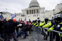 In this Jan. 6, 2021 file photo, Trump supporters try to break through a police barrier at the ...