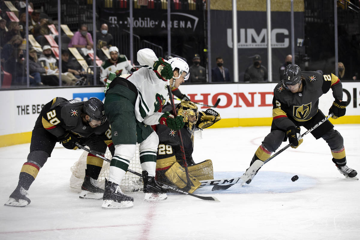 Golden Knights defenseman Zach Whitecloud (2) defends while goaltender Marc-Andre Fleury (29) s ...