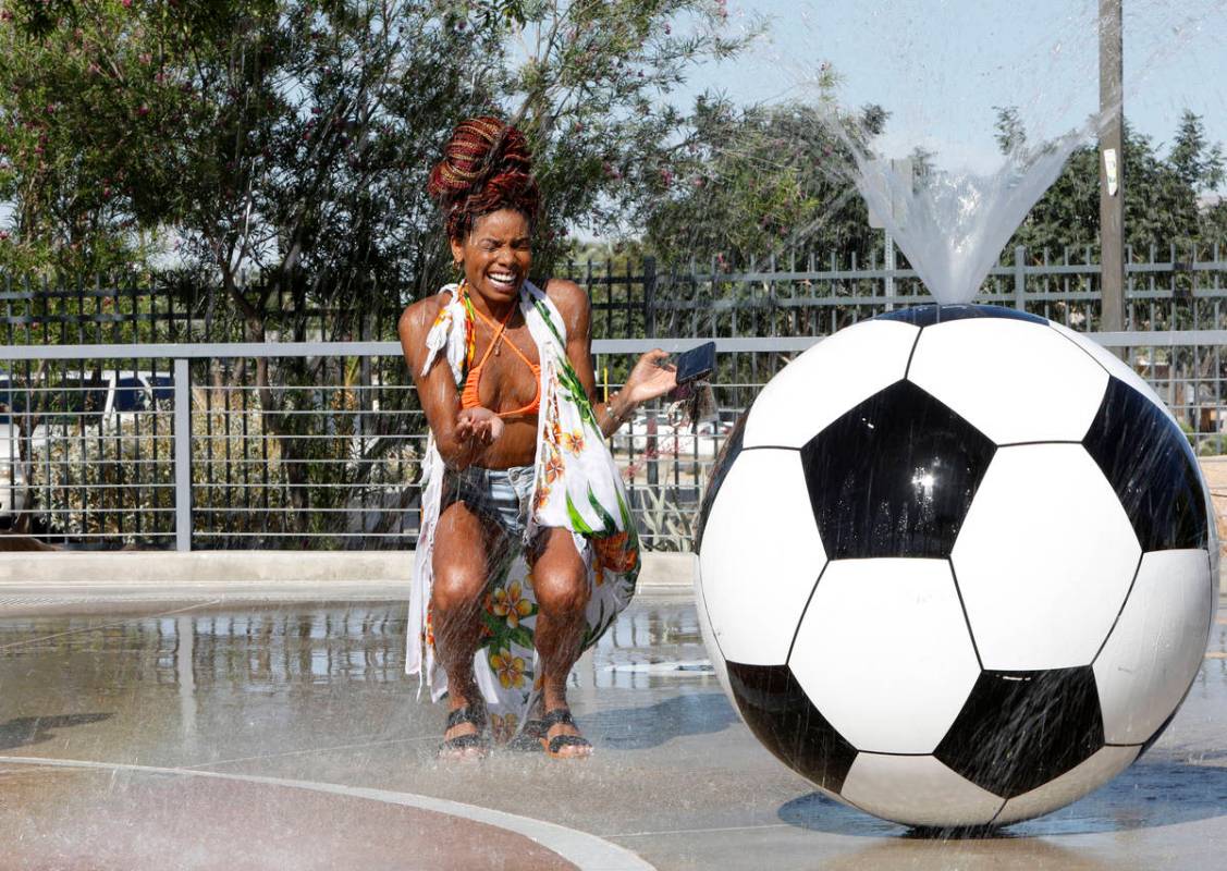 Kristin Jackson of Las Vegas cools off in the splash pad at Baker Park in Las Vegas, Wednesday, ...