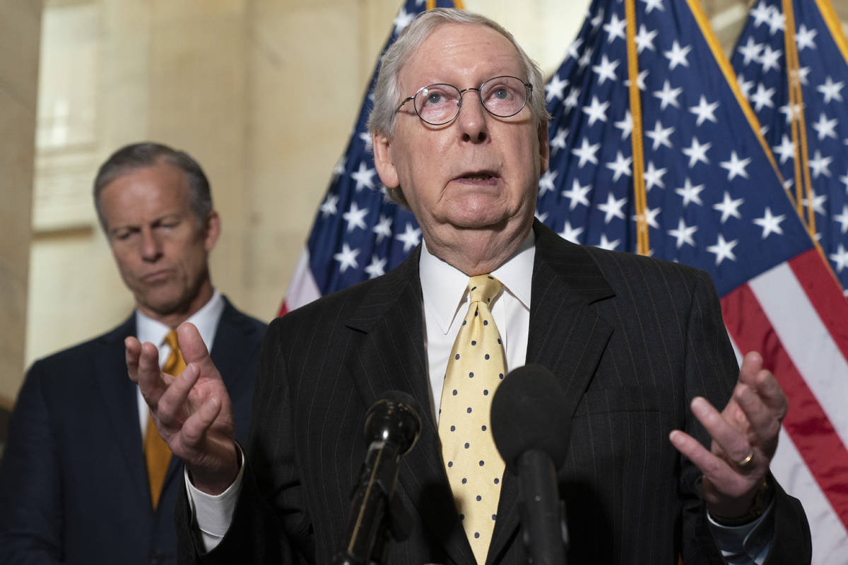 Senate Minority Leader Mitch McConnell of Ky., right, speaks to the media next to Sen. John Thu ...