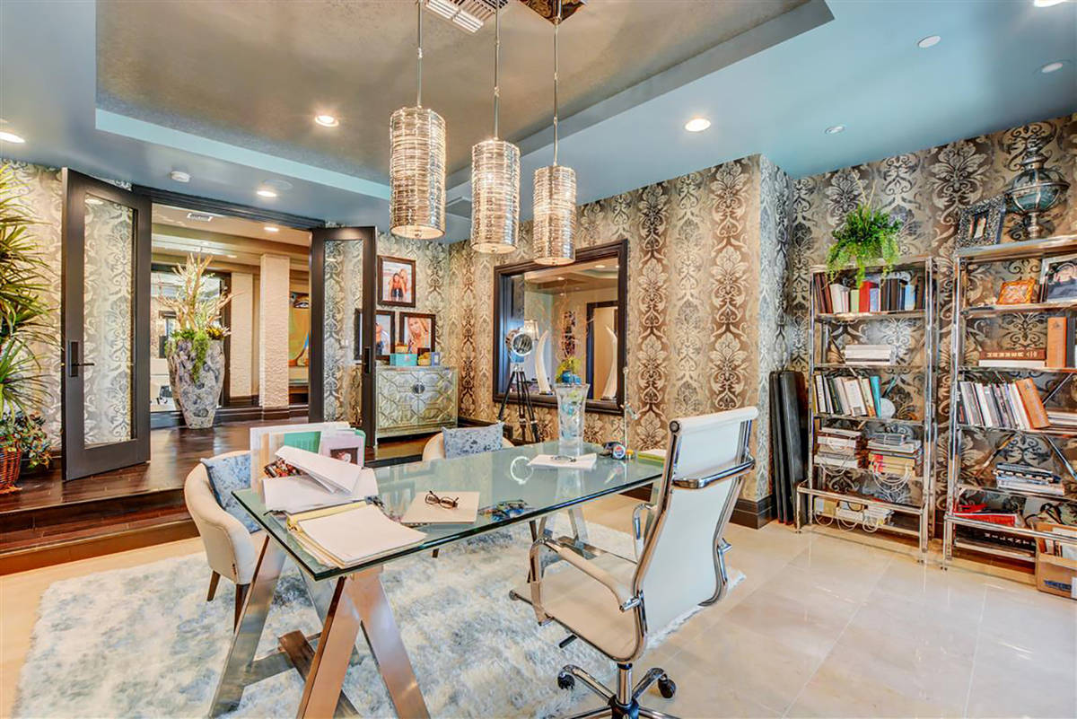 An office on the lower level walks out to a backyard waterfall. (Keller Williams)