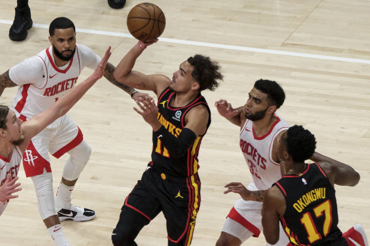 Atlanta Hawks guard Trae Young (11) shoots against the Houston Rockets during the first half of ...