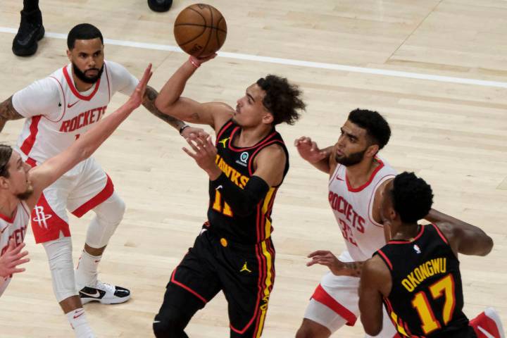 Atlanta Hawks guard Trae Young (11) shoots against the Houston Rockets during the first half of ...