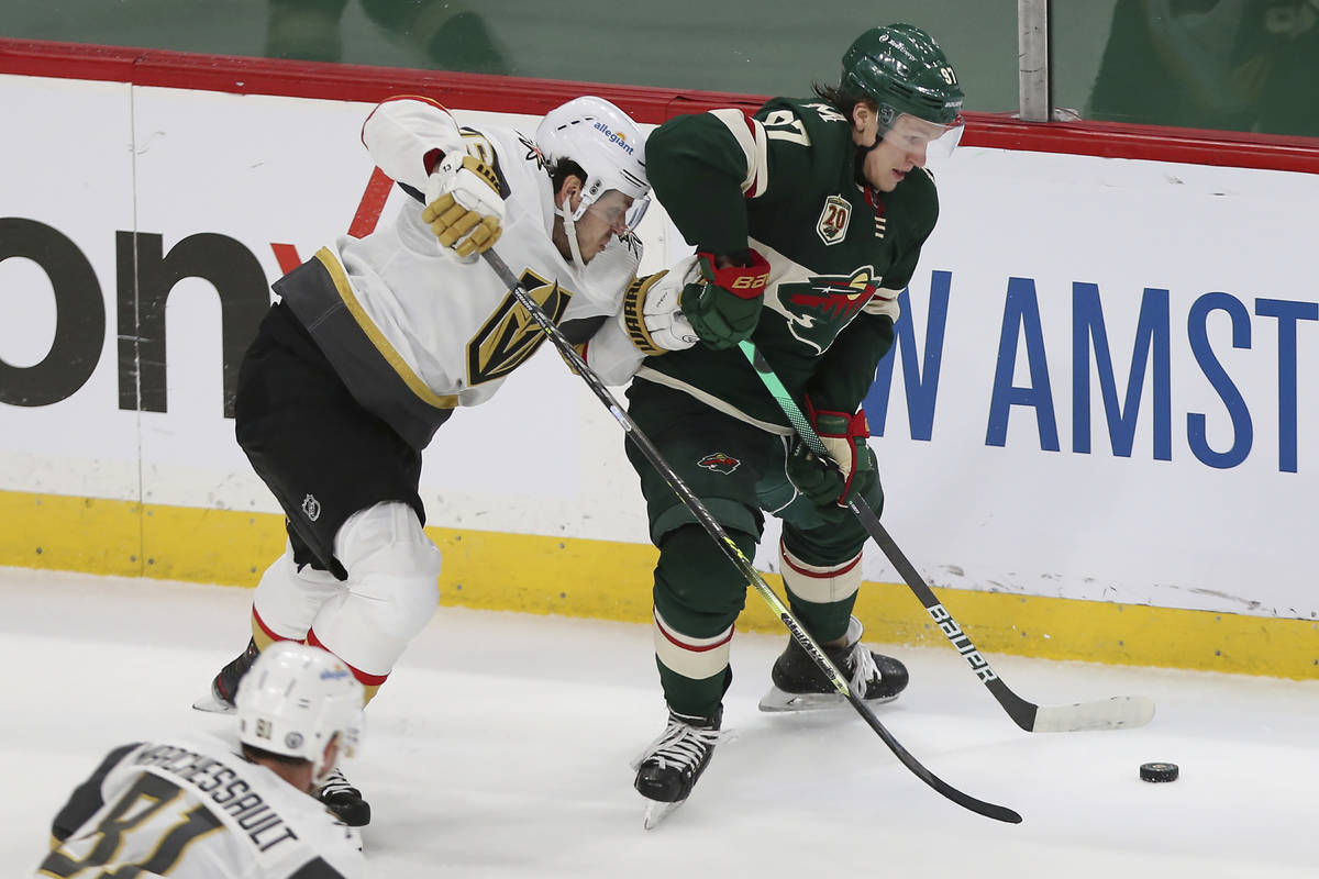 Minnesota Wild's Kirill Kaprizov (97) handles the puck next to Vegas Golden Knights' Mattias Ja ...