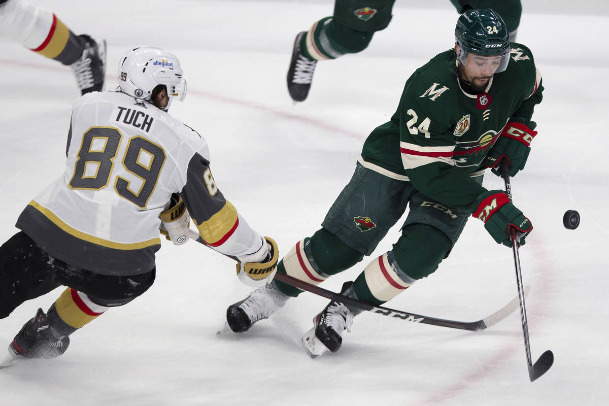 Minnesota Wild's Matt Dumba (24) goes after the puck next to Vegas Golden Knights' Alex Tuch (8 ...