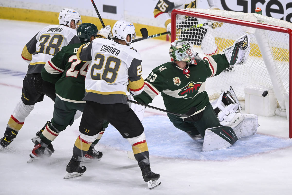 A shot by Vegas Golden Knights center Patrick Brown (38) goes past the glove of Minnesota Wild ...