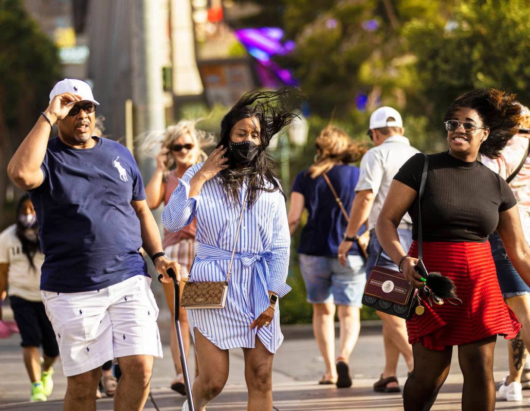 Larry, left, and Kim Edwards with Melissa Williams, from Alllendale, Michigan, battle high wind ...