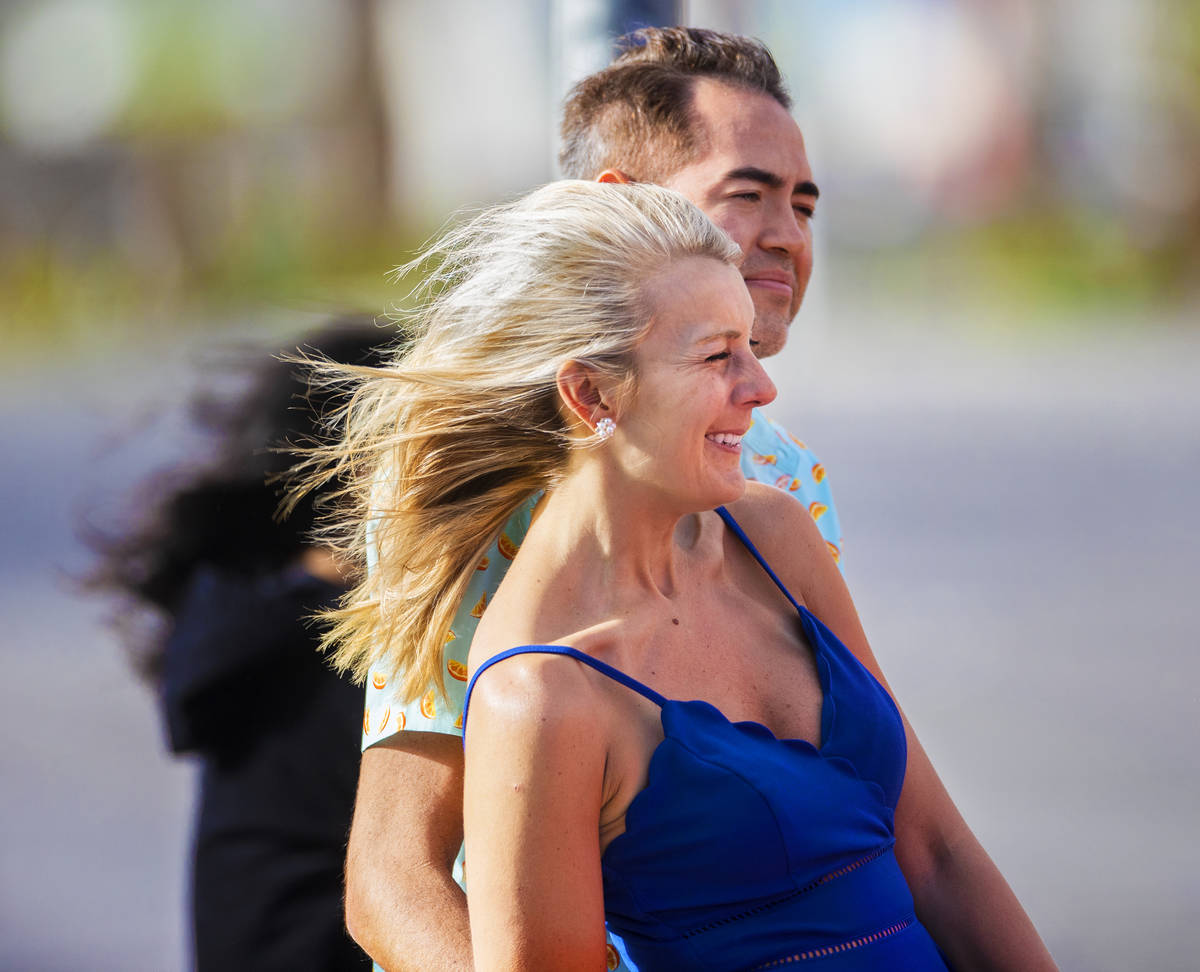 Stephanie Roberts, from Dallas, Tex., waits to cross the street in high winds on the Strip on T ...