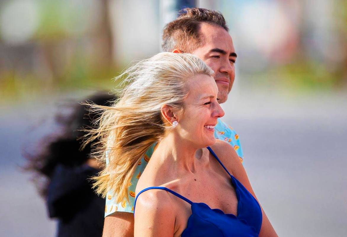 Stephanie Roberts, from Dallas, Tex., waits to cross the street in high winds on the Strip on T ...