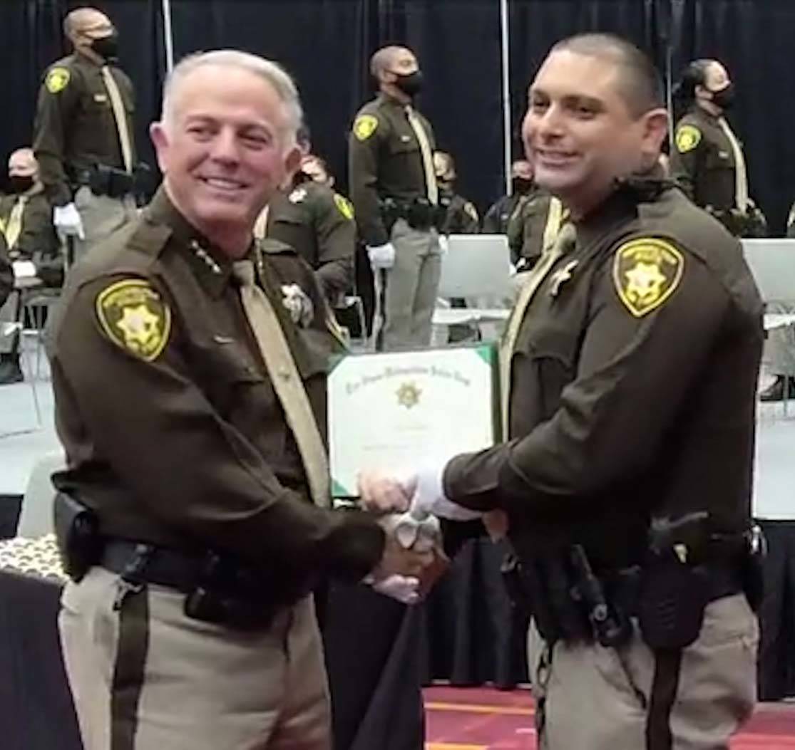 Clark County Sheriff Joe Lombardo, left, congratulates one of the 81 Las Vegas Metropolitan Pol ...