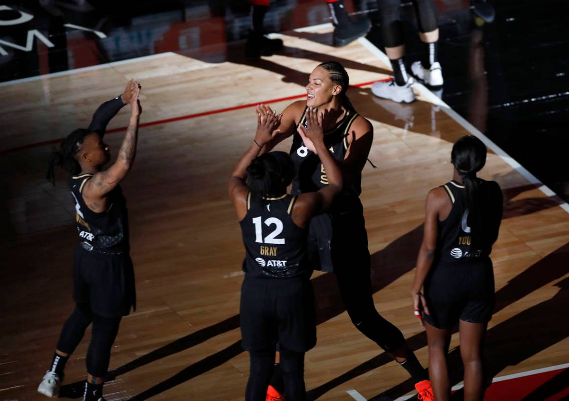 Las Vegas Aces center Liz Cambage (8), center, is introduced before a WNBA basketball game agai ...