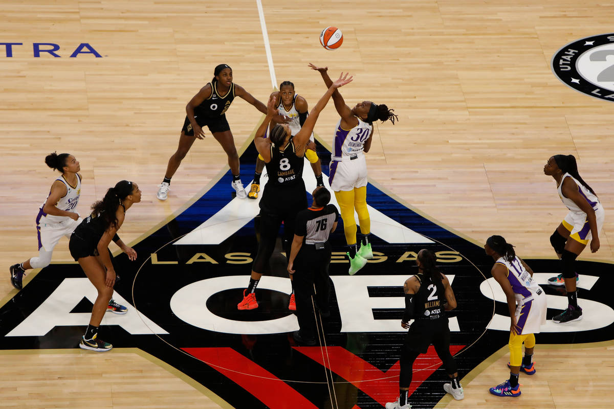 Las Vegas Aces center Liz Cambage (8) tips-off against Los Angeles Sparks forward Nneka Ogwumik ...