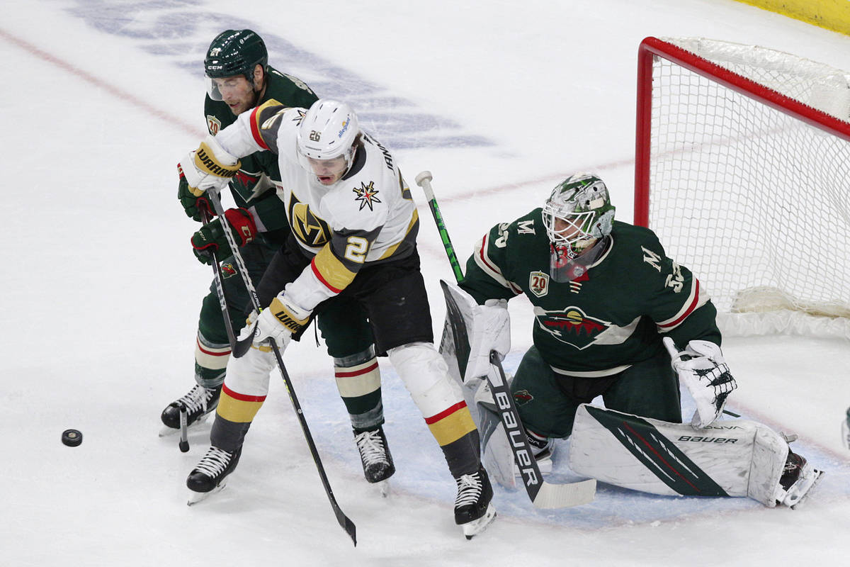 Vegas Golden Knights center Mattias Janmark (26) battles for the puck with Minnesota Wild defen ...