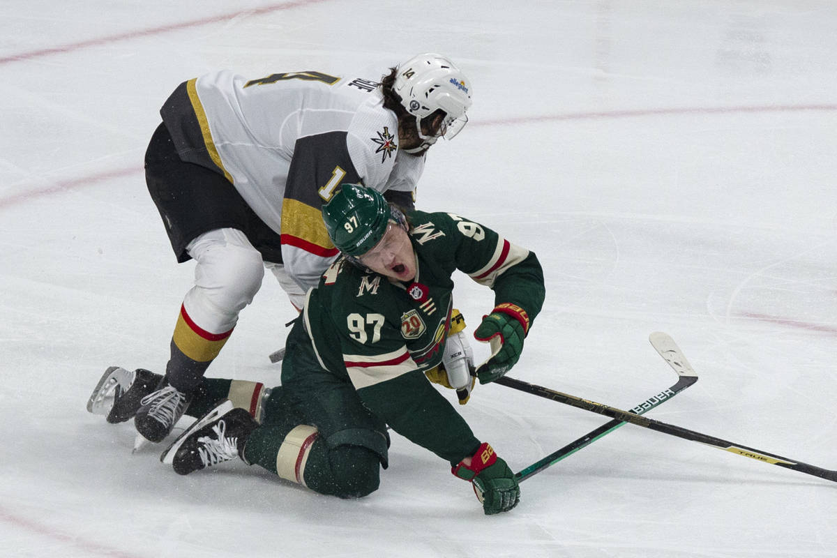 Minnesota Wild left wing Kirill Kaprizov (97) is hit by Vegas Golden Knights defenseman Nicolas ...