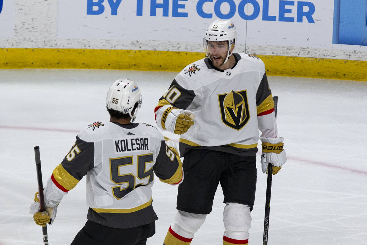 Vegas Golden Knights center Nicolas Roy (10) celebrates his goal with Keegan Kolesar (55) in th ...