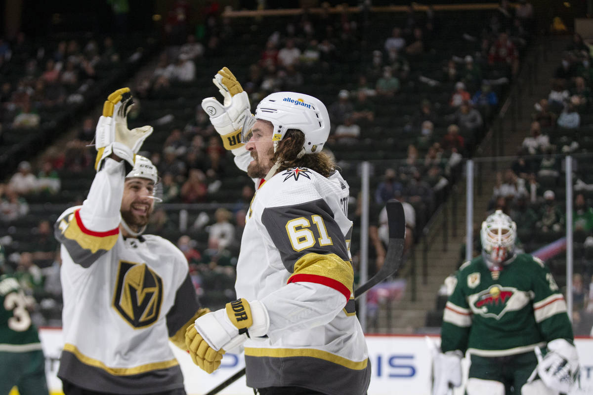 Vegas Golden Knights right wing Mark Stone (61) with defenseman Nicolas Hague (14) after scorin ...