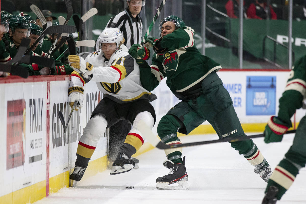 Minnesota Wild left wing Jordan Greenway (18) hits Vegas Golden Knights center William Karlsson ...