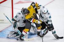 Golden Knights center Cody Glass (9) looks to get the puck into the net past San Jose Sharks go ...