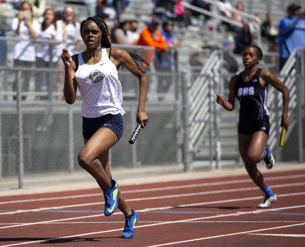 Centennial's Xiamara Young, left, competes in the girls 4x400 race during the class 5A Southern ...