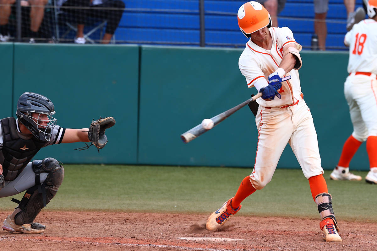 Bishop Gorman High's right fielder Tyler Whitaker connects with the ball against Palo Verde dur ...