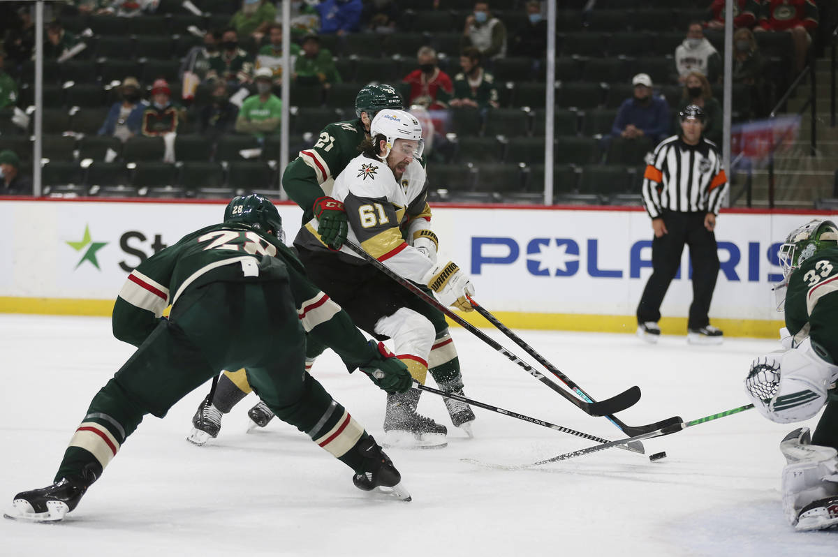 Vegas Golden Knights' Mark Stone (61) tries to get the puck in the net against Minnesota Wild's ...