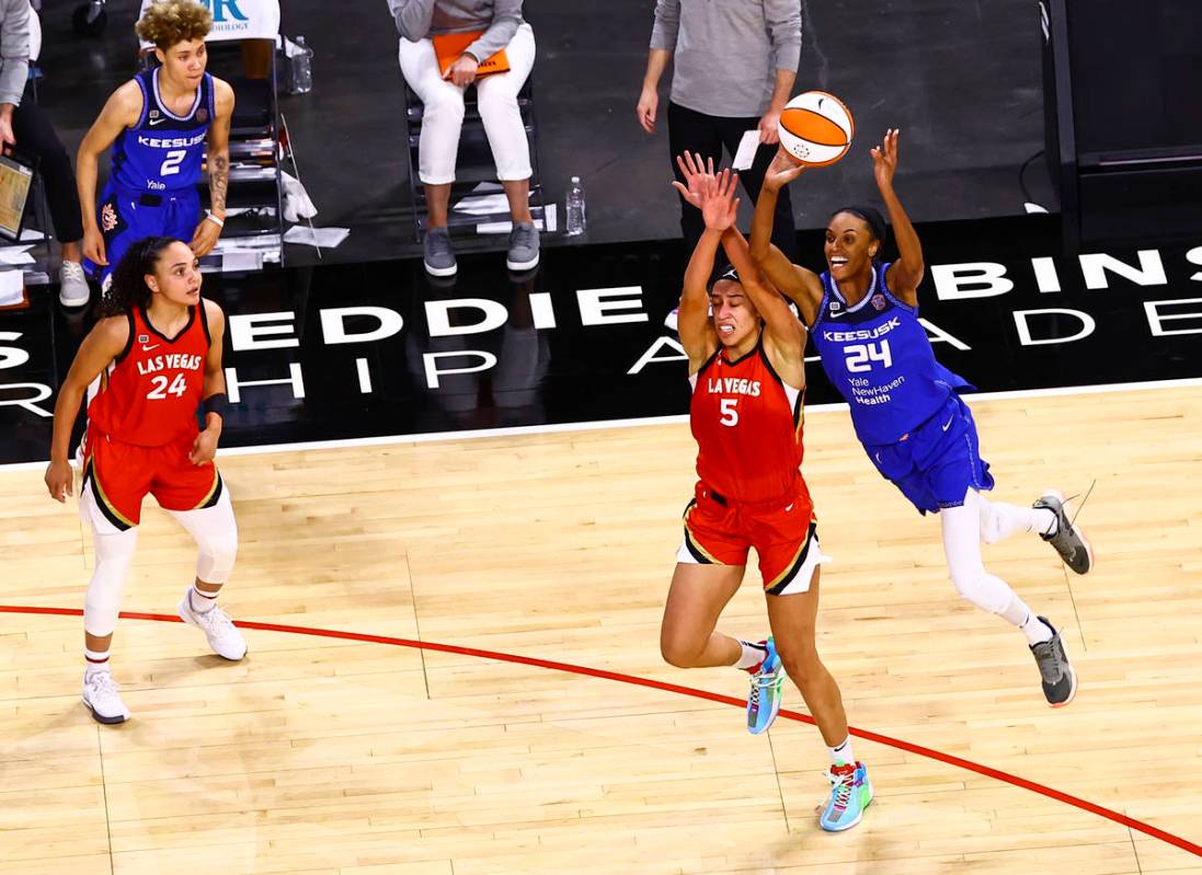 Connecticut Sun's DeWanna Bonner (24) shoots over Las Vegas Aces' Dearica Hamby (5) during the ...