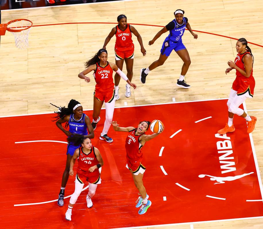 Las Vegas Aces' Dearica Hamby (5) reaches out for a rebound in front of Connecticut Sun's Beatr ...