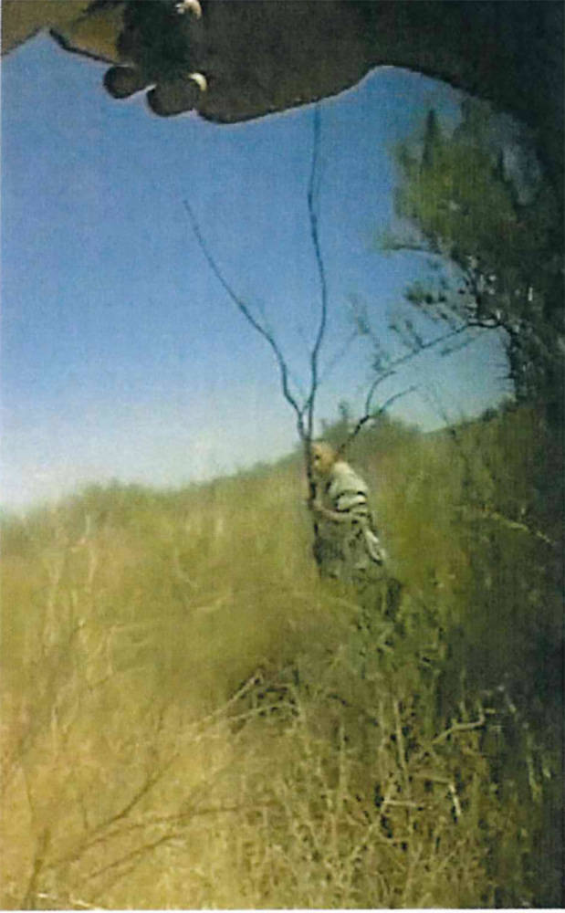 Body camera image shows Jackie Ray Harry with a large tree branch. (Pershing County)