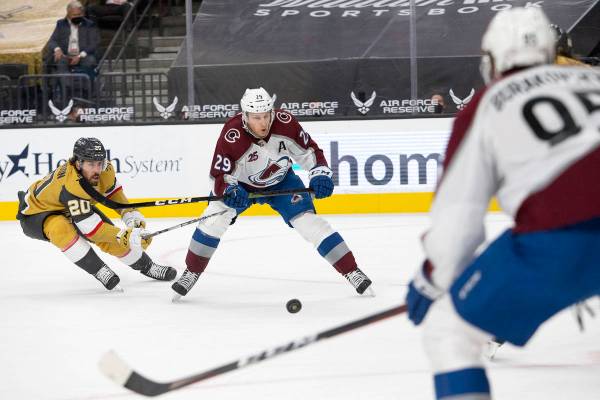 Golden Knights center Chandler Stephenson (20) and Avalanche center Nathan MacKinnon (29) compe ...